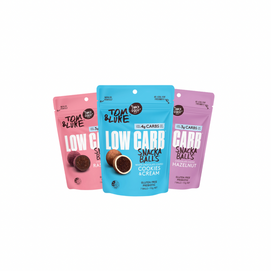 Three packages of Chocolate coated Tom & Luke Low Carb Snack Balls on a white background. Cookies and Cream, Raspberry and Hazlenut. Delicious and nutritious healthy snacks from New Zealand. 