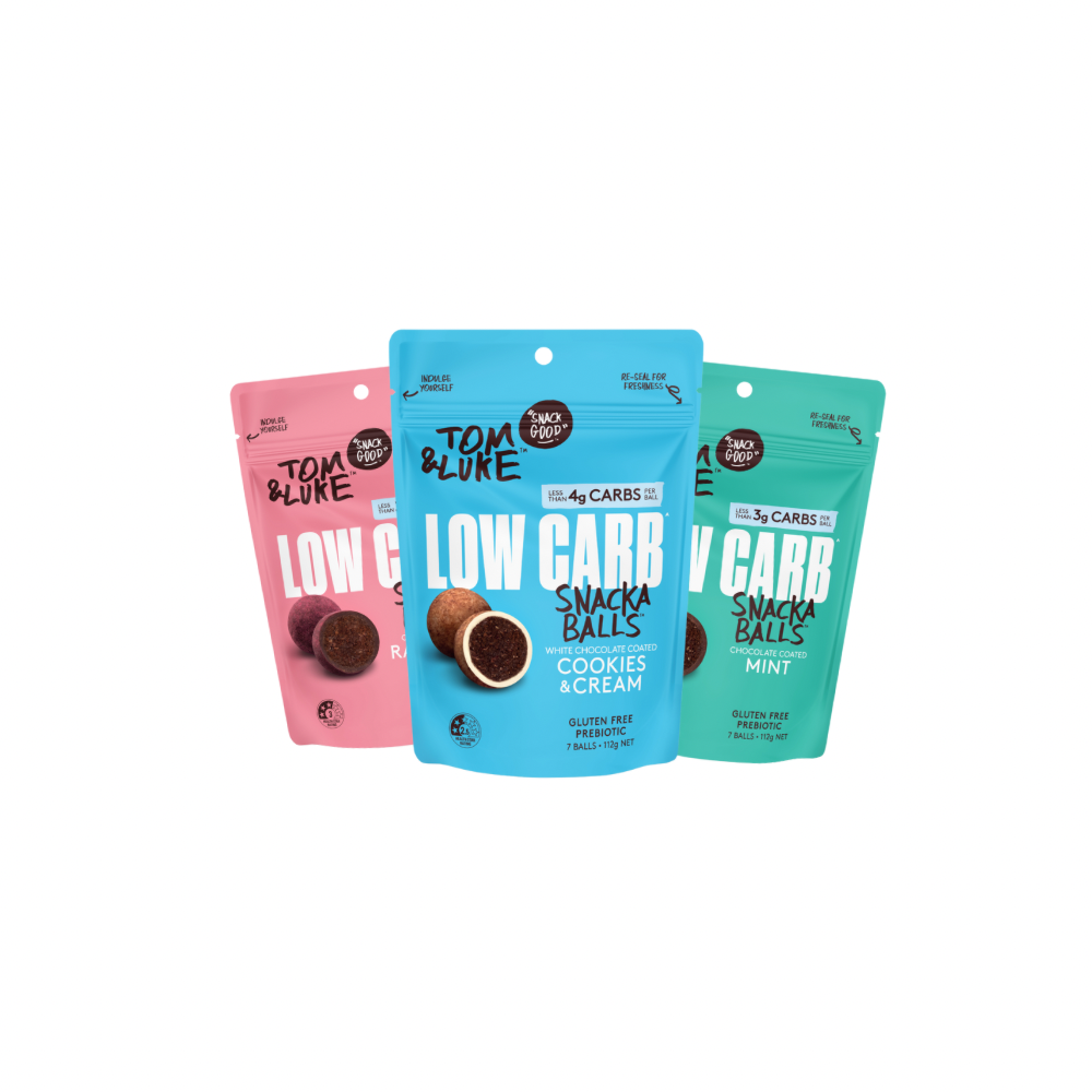 Three packages of Chocolate coated Tom & Luke Low Carb Snack Balls on a white background. Cookies and Cream, Raspberry and Mint. Delicious and nutritious healthy snacks from New Zealand. 